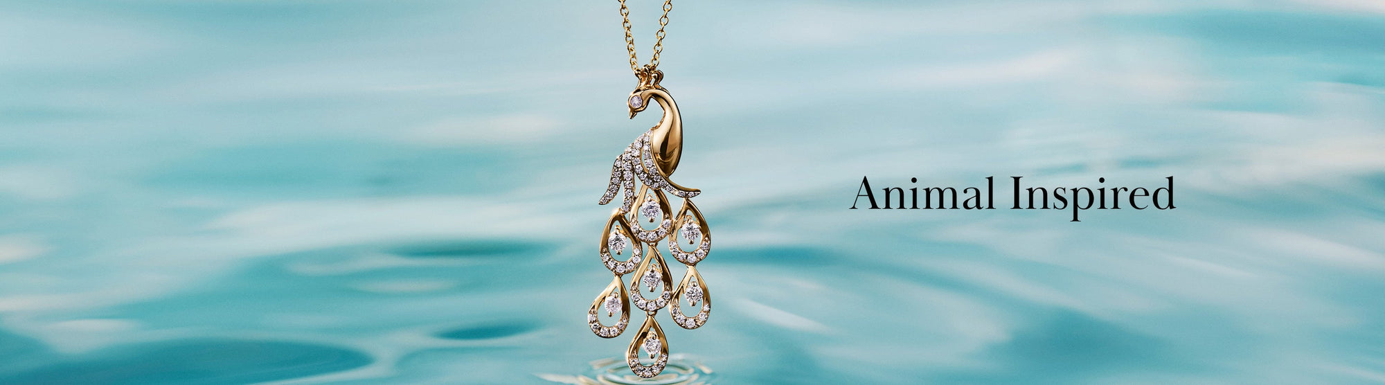 A woman wearing patterned clothing and stacked rings stands by the beach; text on the left reads Animal Inspired.