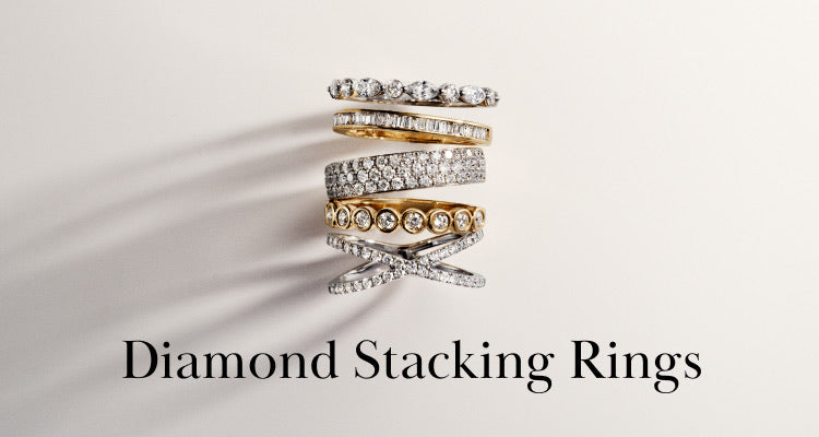 A collection of seven diamond stacking rings in gold and silver metals displayed in a vertical stack on a light background, with the text Diamond Stacking Rings below.