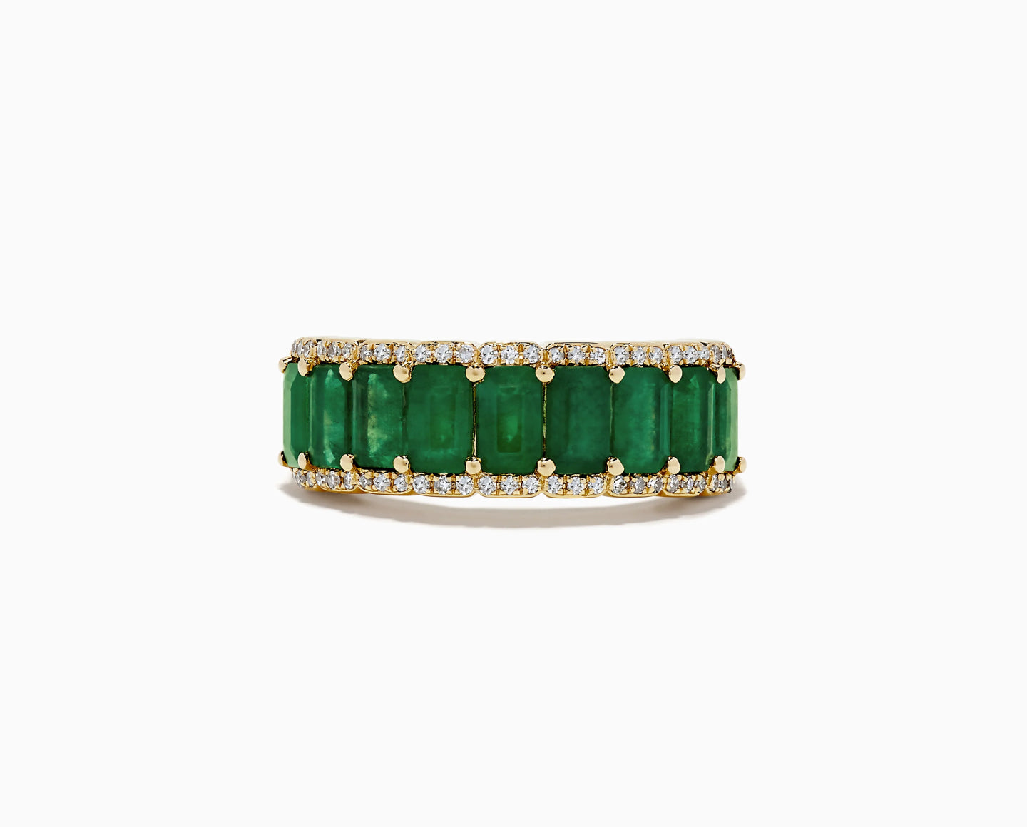 A gold ring with a row of rectangular green gemstones, framed on both edges by small, round white diamonds. The ring has a bold and elegant design.